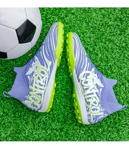Detailed view of lilac mid-high top soccer cleats on green turf with soccer ball