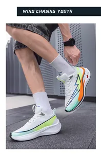 Close-up of lightweight breathable white mesh running shoes with neon green and orange details