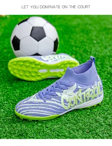 Detailed view of purple high-top soccer shoes on grass with soccer ball background