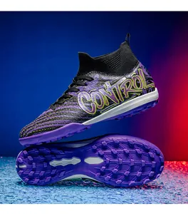 Detailed view of purple TF turf soccer shoes showing the traction sole and side design