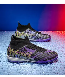 Detailed shot of purple high-top soccer shoes with knit collar and turf studs