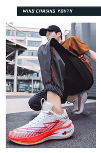 White and red breathable mesh running shoes shown on an Asian male model outdoors