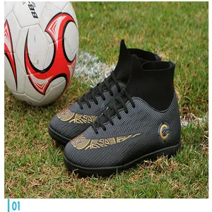 High-top black and gold soccer shoes with textured upper on natural grass field detail