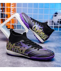 Macro shot of high-top soccer cleats with purple knit mesh and CONTROL lettering.
