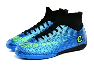 Detail view of blue high-top soccer shoes with turf cleats and knit collar.