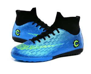 Detailed side view of blue high-top turf soccer shoes with black sock collar and green graphics