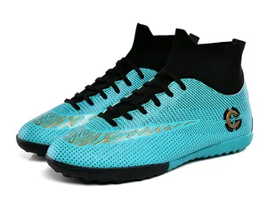 Detail of cyan high-top soccer cleats featuring honeycomb texture and stylish gold accents