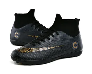 High-top soccer cleats in black and gold with detailed geometric patterned finish