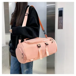 Pink multi-functional gym bag with shoulder strap shown in a professional lifestyle setting.