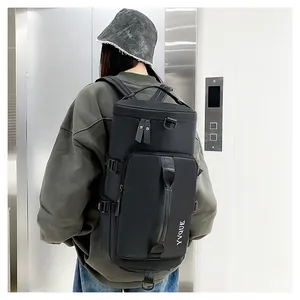 Detail view of a black multi-functional sports and travel backpack worn on the back