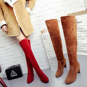 Over-the-knee suede boots in red and brown with chunky high heels