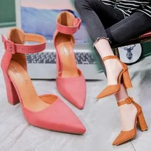 Detailed view of pink and brown pointed toe high heels with chunky heels and ankle straps