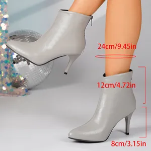 Detailed view of grey pointed-toe stiletto ankle boots with heel height measurement