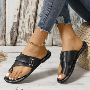 Detail view of black toe-loop flat sandals with buckle detail for summer leisure