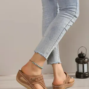 Close-up detail of comfortable brown wedge sandals with toe-clamping design