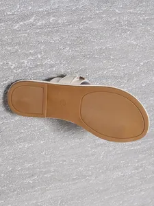 Close-up detail of the anti-slip textured brown sole and size 37 mark of women slipper.
