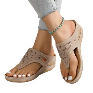 Comfortable women's platform thong sandals featuring floral cutout design and wedge sole