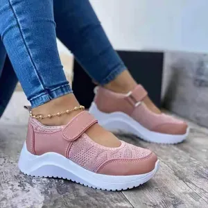 Close-up detail of pink Mary Jane sneakers featuring breathable mesh and velcro straps