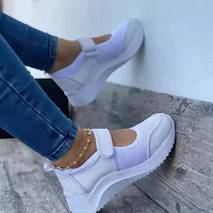 Side view of white women's platform sneakers with velcro strap and breathable mesh