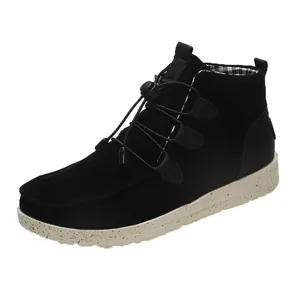 Detail view of women's black suede flat ankle boots featuring a toggle lacing system.