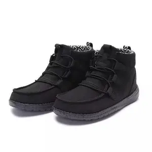 Detailed view of black casual ankle boots with speckled soles and elastic laces
