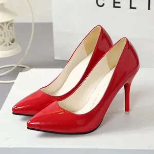 Macro detail view of elegant glossy red patent leather pointed-toe stiletto high heels