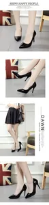 Detail view of black patent leather pointed-toe stiletto heels on model