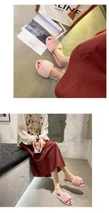 Detail view of pink fuzzy slippers for women featuring a warm flat plush design for home