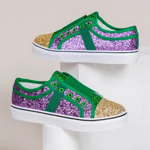 Close-up of colorful glitter sequin low-top sneakers on white display pedestals