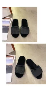Detail view of plush black faux fur indoor slippers with soft footbed.