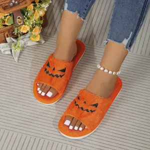 Detail view of vibrant orange fluffy pumpkin slippers for cozy Halloween home indoor wear