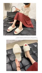 Close-up of cozy white fluffy house slippers for women featuring soft faux fur straps.