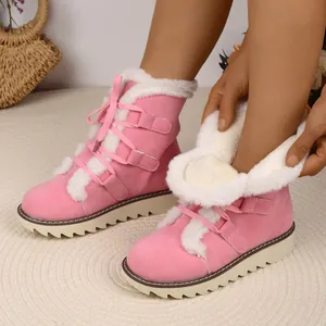 Stylish pink faux fur lined snow boots for women with lace-up detail and thick non-slip sole