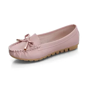 Side view detail of pink women's moccasins with bow accent and non-slip flat rubber sole