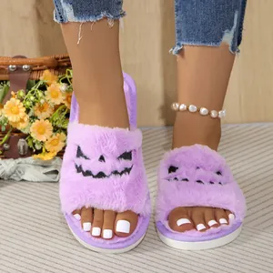 Detailed macro view of purple furry Halloween slippers with spooky pumpkin face embroidery