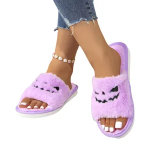 Purple fuzzy Halloween slippers for women featuring a spooky pumpkin face design slides