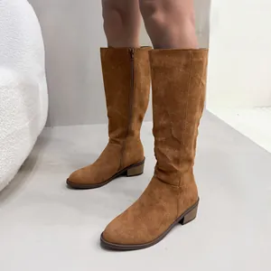Detailed view of brown faux suede knee-high boots with side zipper and low block heel