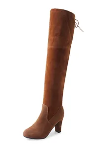 Side view detail of stylish brown suede over-the-knee boots with chunky high heel