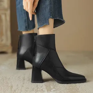 Black pointed-toe block heel ankle boots with back zipper and leather-like texture