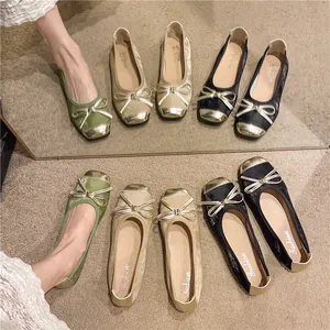 Detail view of retro ballet flats with bow and gold toe cap in multiple colors
