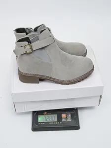 Suede Martin ankle boots with buckle strap weighing 728g on a digital scale.