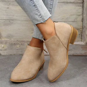 Stylish beige pointed-toe Chelsea boots shown on feet for a trendy British look.