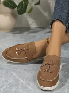 Vue détaillée de mules en daim marron avec une boucle dorée élégante sur le dessus