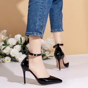 Detailed side view of elegant black patent leather pointed toe stiletto heels with ankle strap