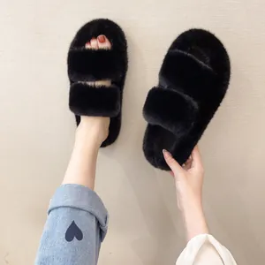 Detail view of stylish black fluffy double-strap slippers with soft faux fur texture.