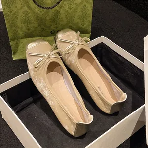 Detailed view of vintage champagne ballet flats with elegant bow-knot and round toe