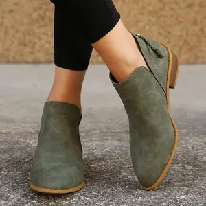 Detail showing the pointed-toe and side-cut design of the olive green ankle boots