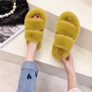 Close-up view of stylish yellow platform fuzzy slippers with double bands and open-toe design