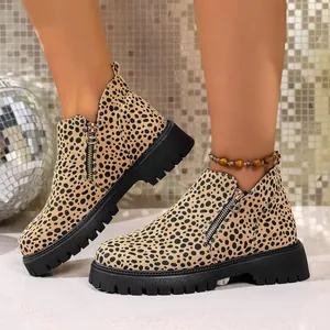 Detailed view of leopard print ankle boots with side zipper and thick sole
