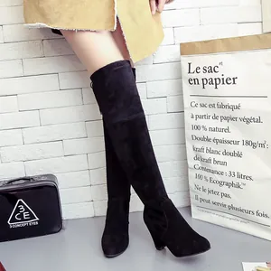 Detail view of black suede over-the-knee boots with chunky high heels